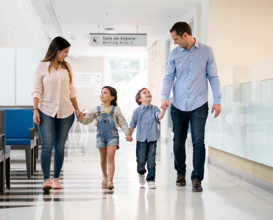 happy family walking at the primary care hallway